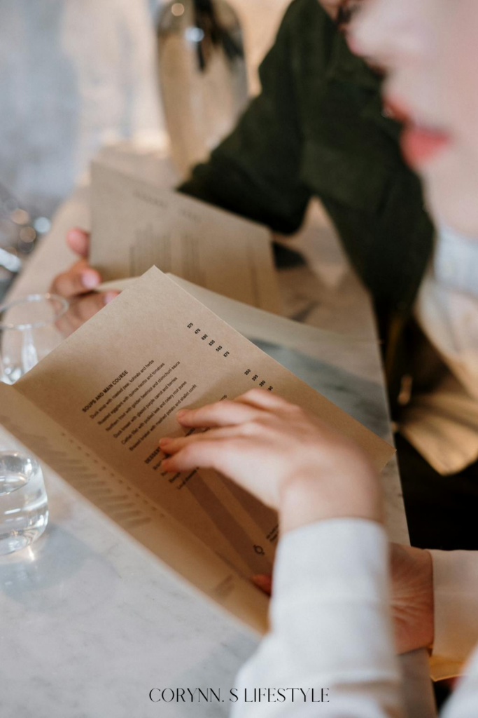 Couple sitting at the restaurant looking over the menu. Non-kitchen registry items.