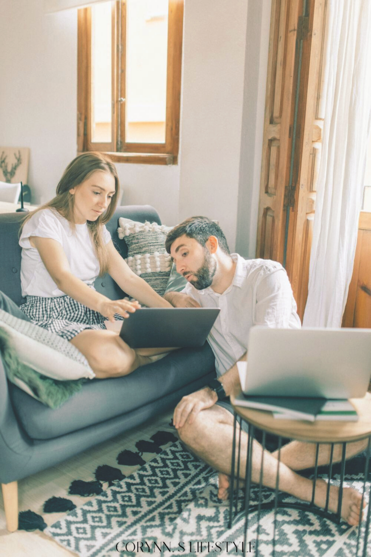 couple sitting together look at each others laptop. Non-kitchen registry ideas