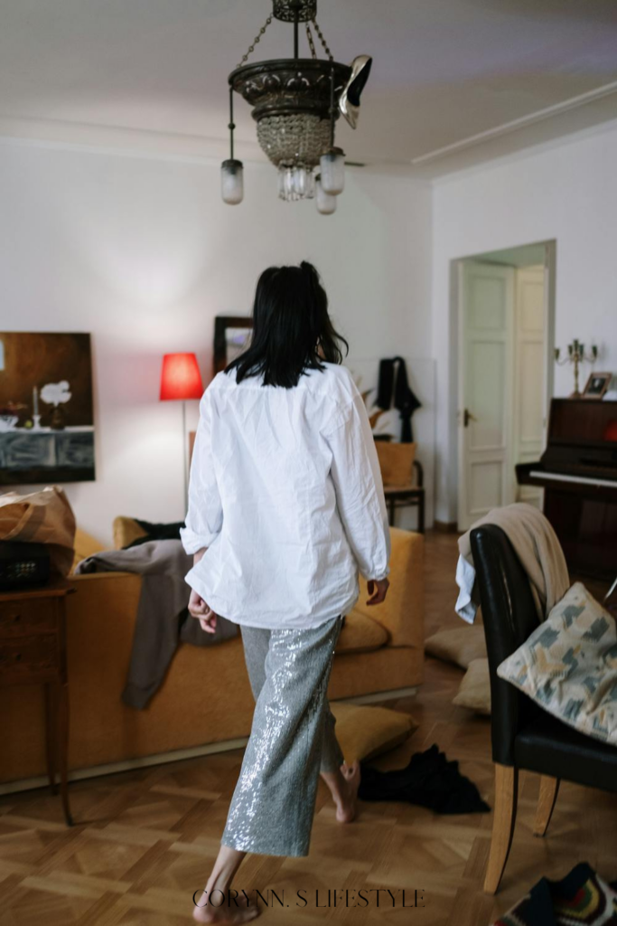 Photo of a girl walking around a messy apartment. Warning signs of a bad apartment. 